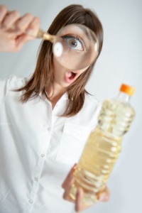 Blog53-Woman-Inspecting-Oil-Bottle-a