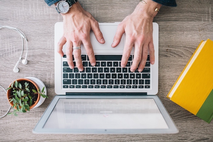 Hands-Typing-Wood-Background-Computer.jpg